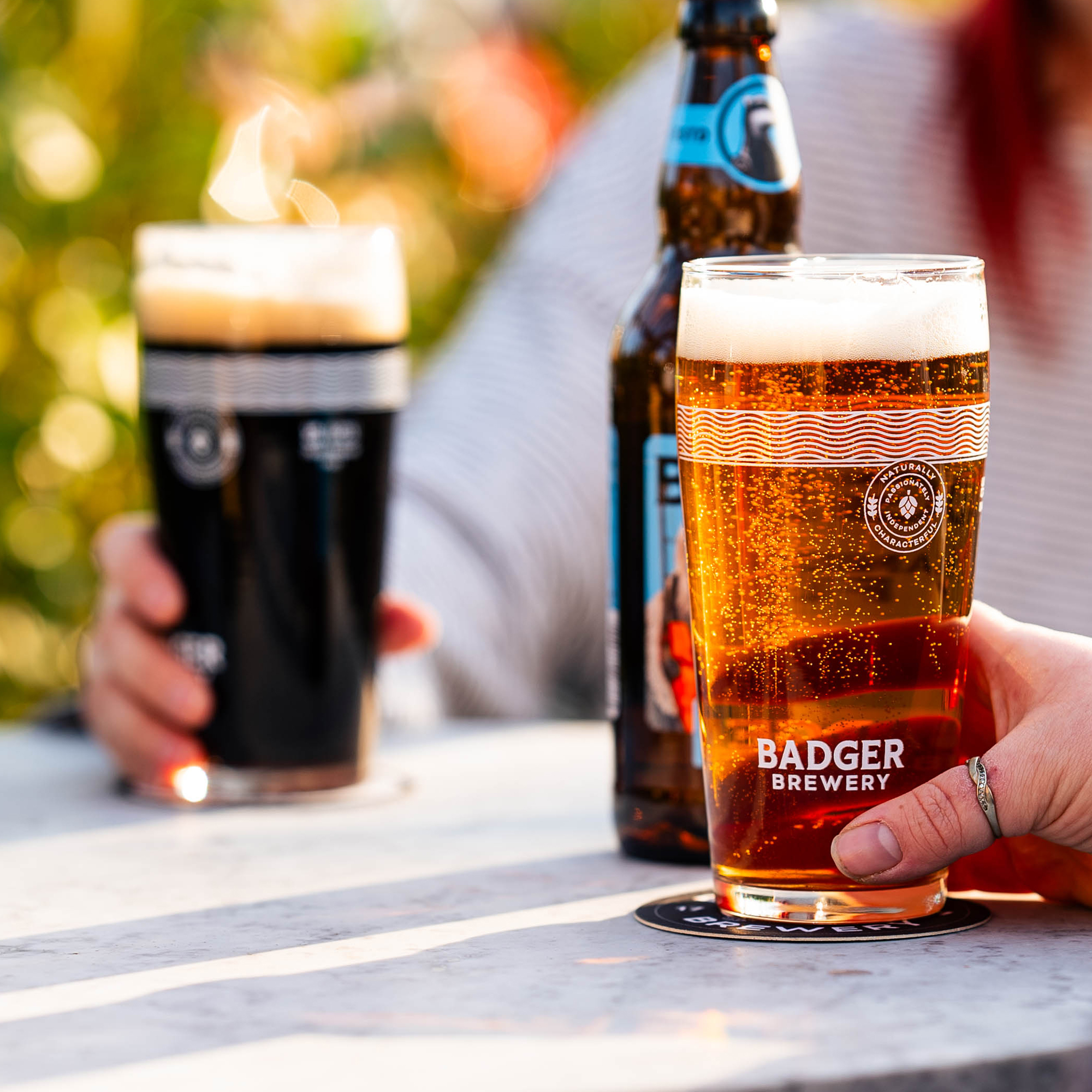 People holding Badger Pint Glasses